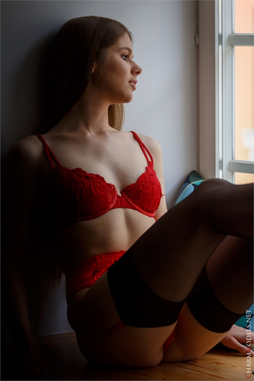 Evelina on the window in red lingerie Charmmodels.net