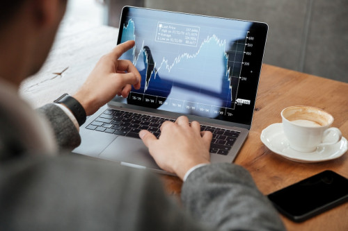 businessman-sitting-by-table-analyzing-Transfer-and-Transmission-of-Shares.jpg