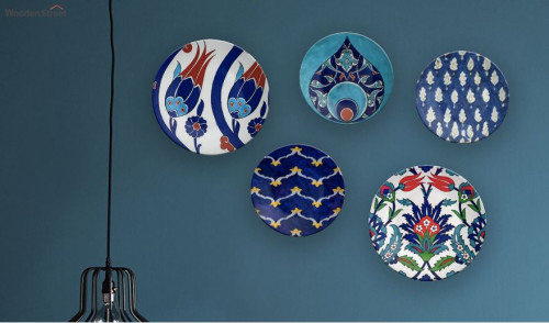 The plates are a deceptively important object in the kitchen and any gourmet of handmade pottery. Today, now they serve as works of aesthetic art and play a crucial role in decorating your interiors. For more Information visit here: https://www.woodenstreet.com/wall-plates